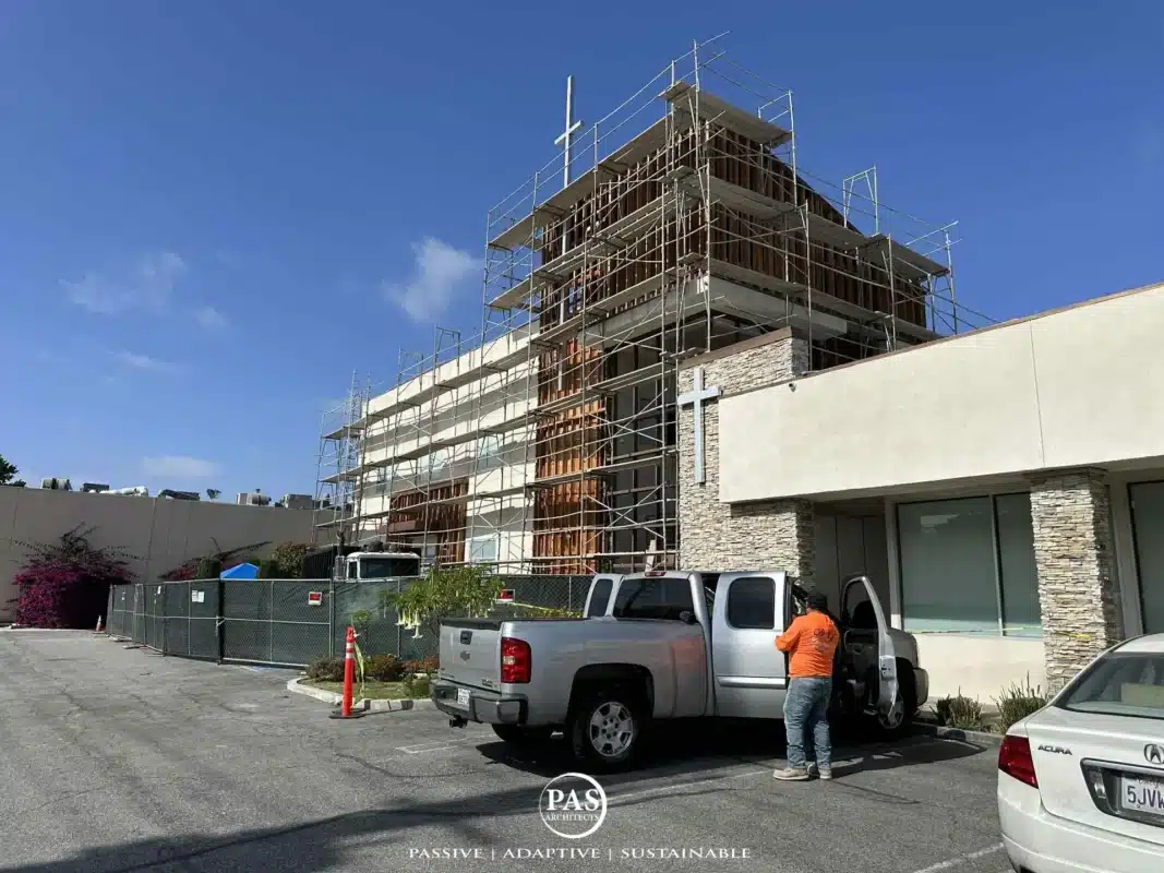 Exterior view of Korean Church of Southwest LA during Education Hall renovation with scaffolding and vehicles on site.