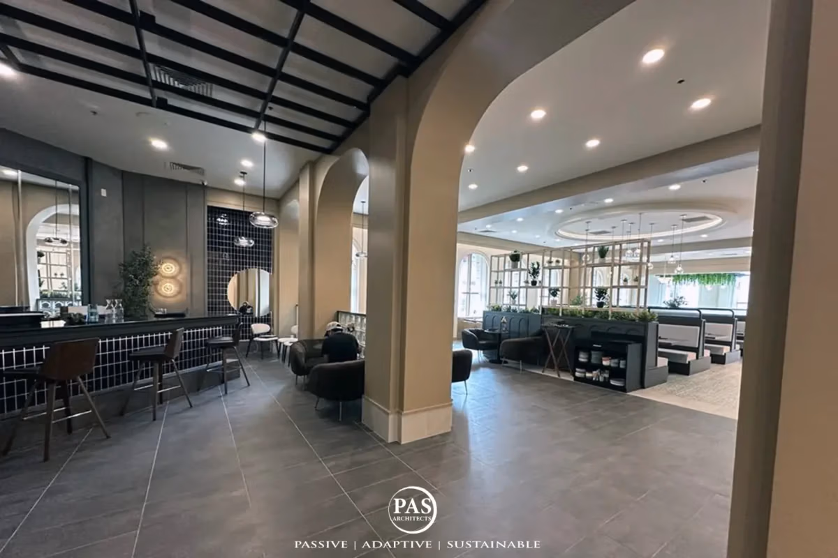 Interior restaurant renovation showing bar and open kitchen integration at Sugo Social